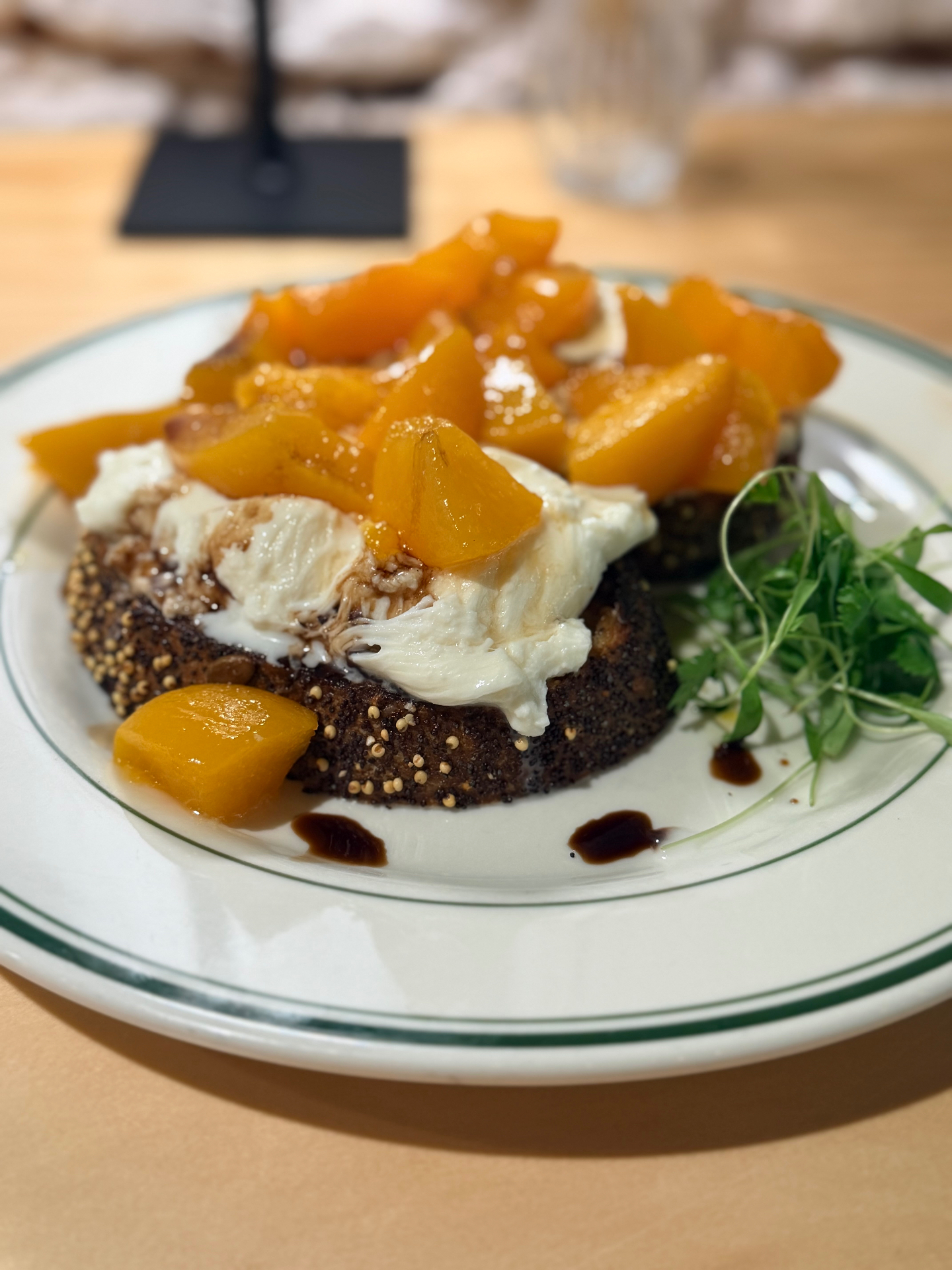 Poppy seed toast with fresh burrata, honeyed peaches, balsamic and micro greens at Brü Avl